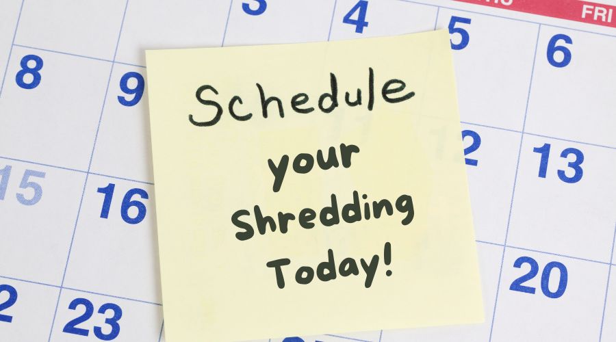 a calendar with a sticky note that says "schedule your shredding today"