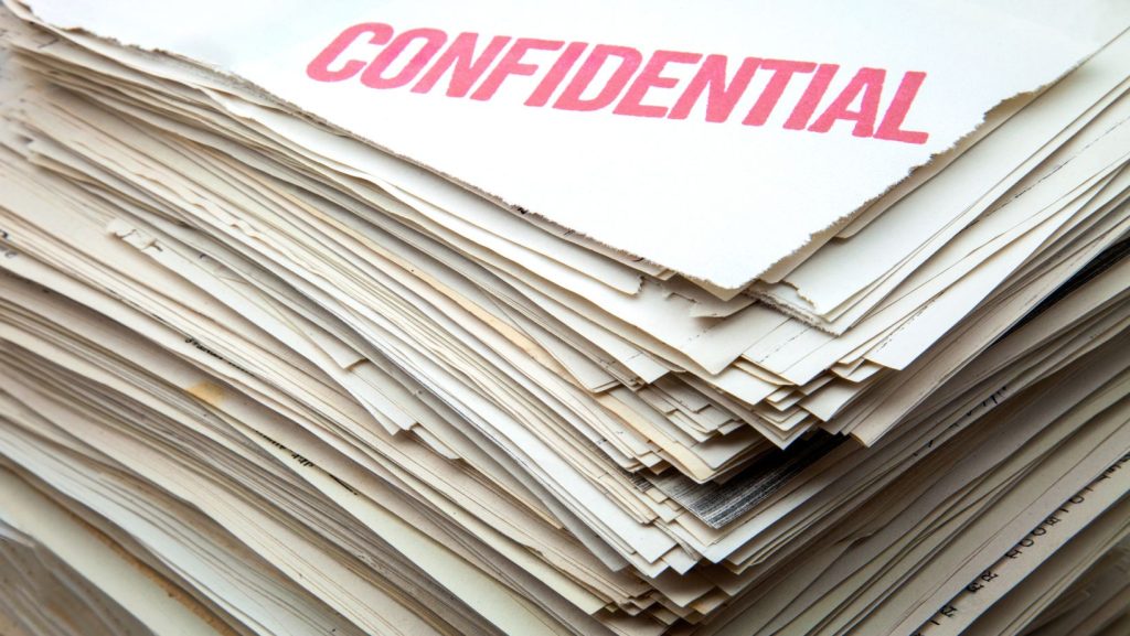 Stack of documents with the word confidential stamped on the top